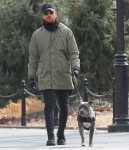 Justin Theroux gets bundled up for a walk with his pit bull