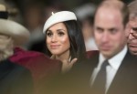 Meghan Markle, wearing a white Stephen Jones beret and a matching Amanda Wakeley crombie coat, attends the Commonwealth Day service at Westminster Abbey with her fiance Prince Harry