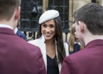 Meghan Markle, wearing a white Stephen Jones beret and a matching Amanda Wakeley crombie coat, attends the Commonwealth Day service at Westminster Abbey with her fiance Prince Harry