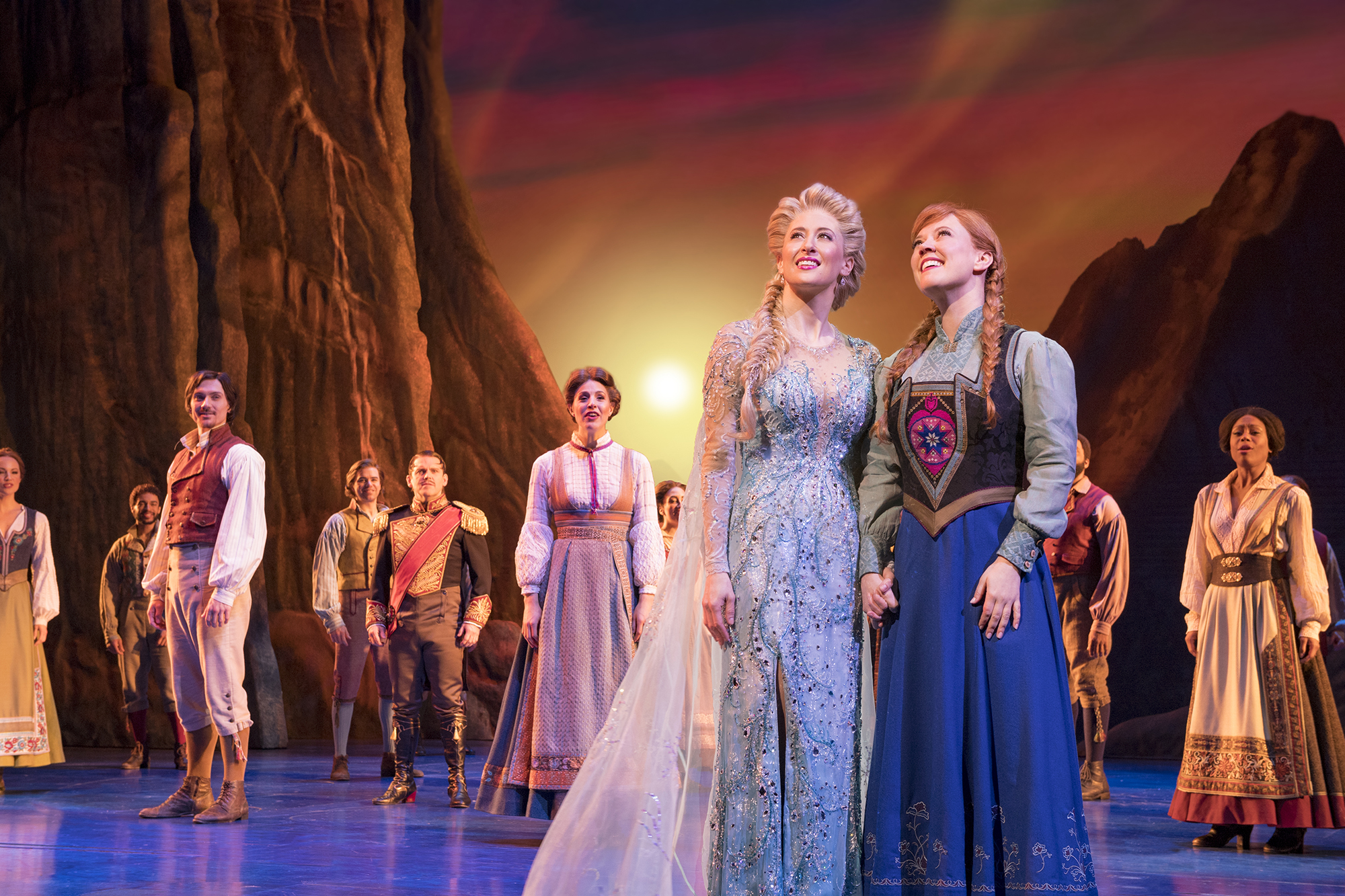 Caissie Levy (as Elsa) and Patti Murin (as Anna), along with the company of Frozen on Broadway.