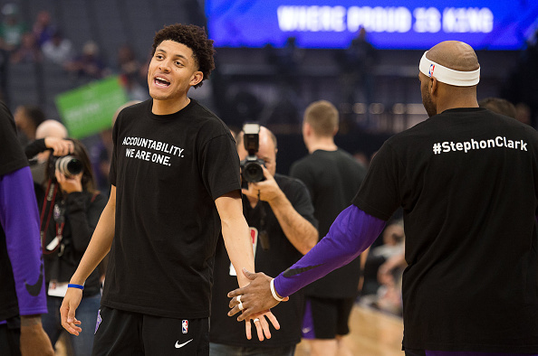 Sacramento Kings forward Justin Jackson (25) slaps hands with Sacramento Kings guard Vince Carter (15) as they wear T-shirts bearing the name of Stephon Clark during a game at Golden 1 Center on Sunday March 25, 2018 in Sacramento, Calif. The Kings and Celtics wore shirts bearing the name of the unarmed man, Stephon Clark, who was killed by Sacramento police. The black warm-up shirts have "Accountability. We are One" on the front and "Stephon Clark" on the back. 