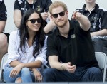 Prince Harry and his girlfriend Meghan Markle watch a wheelchair tennis match as part of the Invictus Games in Toronto