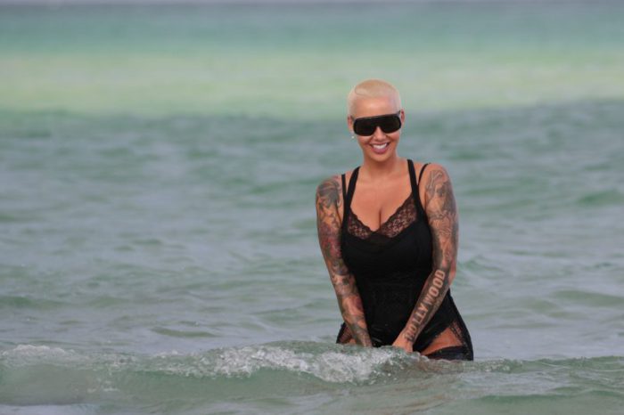 Amber Rose takes a dip in the ocean wearing black lace lingerie in Miami Beach, FL. Amber was relaxing at The Setai hotel with friends and went to cool off in the ocean.