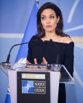 Angelina Jolie speaks to the press after a NATO meeting in Brussels